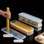 Four clear rectangular reusable plastic food storage containers arranged for refrigerator organization